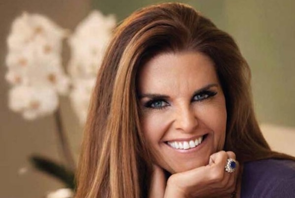 Close-up of Maria Shriver smiling with her hand under her chin.